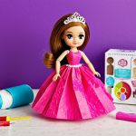 **

DIY LOL Surprise fashion studio. Close-up on miniature ball gown made from paper tissues and scotch tape, displayed on a LOL doll. Background: craft supplies (fabric scraps, beads, glitter), child's hands blurred in motion. Focus on creativity and handmade aspect.

**